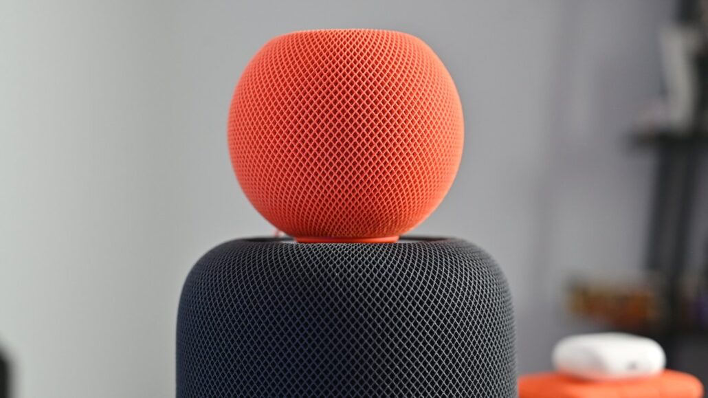 Apple TV HomePod mini updates are waiting for Siris upgrade - Dans Tutorials - Dans Tutorials Red fabric-covered sphere perched on a dark, mesh-coated speaker when viewed up close.
