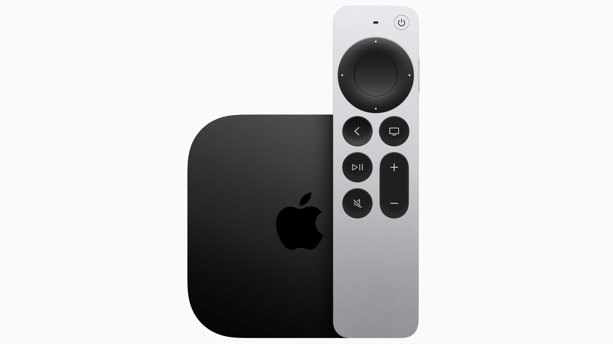 Apple TV remote with a large circular touchpad and multiple dark buttons on a silver body beside a black device with an Apple logo.