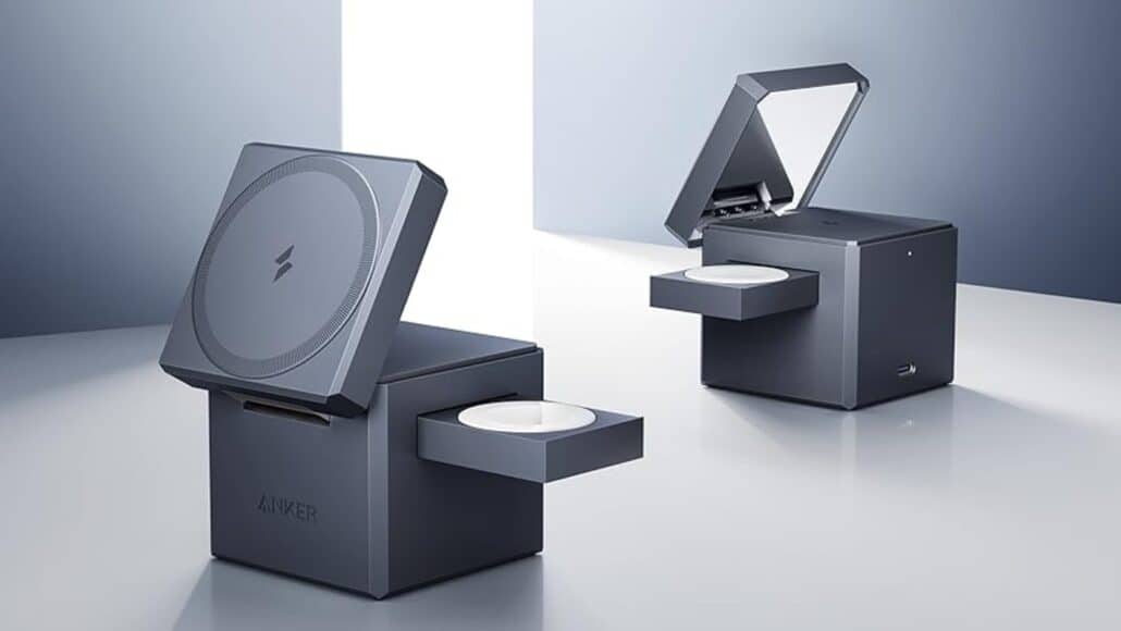Two dark gray cube devices with open lids, each sliding out a white disc from a tray on a glossy surface.