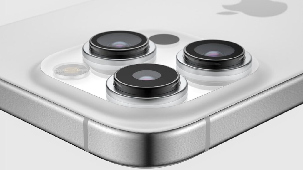 Close-up of a triple-camera system on the back of a white iPhone.