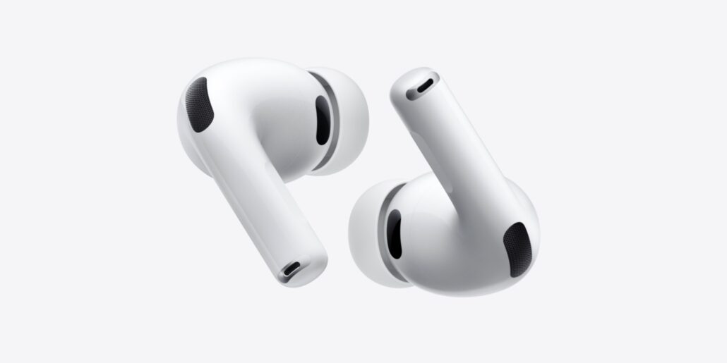 Pair of white wireless earbuds floating against a light gray background, showing their stems and mesh ear tips.
