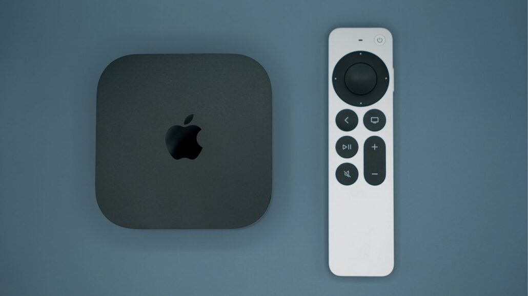 For the first time in four years tvOS cuts off some older Apple TV hardware - Dans Tutorials - Dans Tutorials Apple TV 4K box beside a white remote on a blue surface, viewed from above.