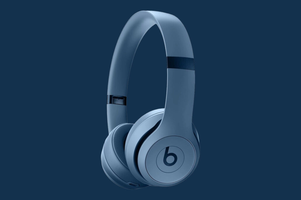 Blue wireless over-ear headphones displayed against a dark navy background (Beats logo on earcup)
