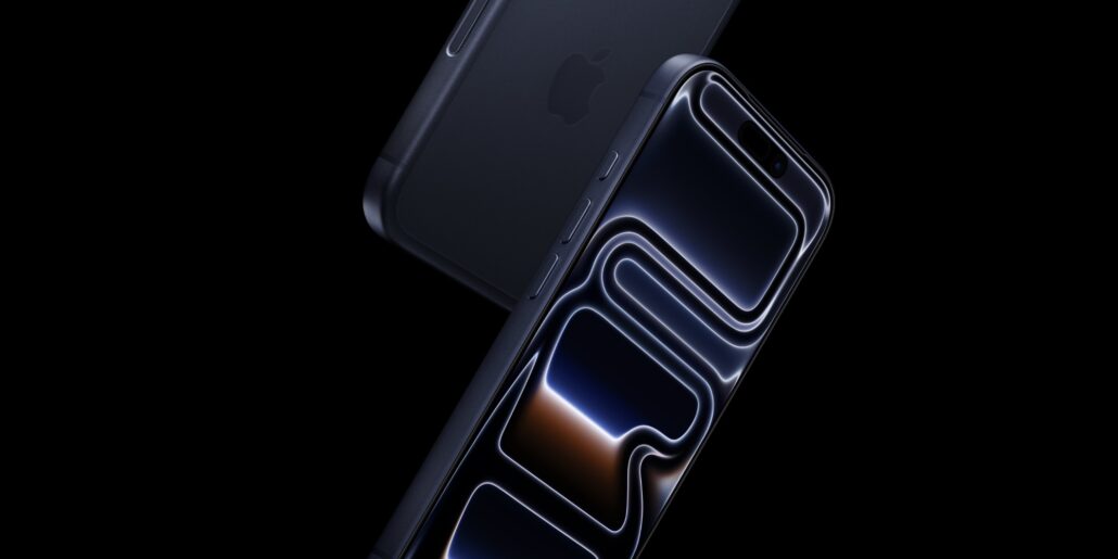 iPhone 18 Pro Three new features might make you want to upgrade - Dans Tutorials - Dans Tutorials Close-up of a dark smartphone with a glossy screen and curved edges against a black background, shown at a diagonal angle.