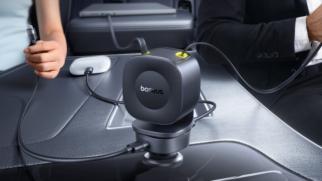 Close-up of a Baseus car mount/device attached to a car dashboard with cables plugged in on both sides