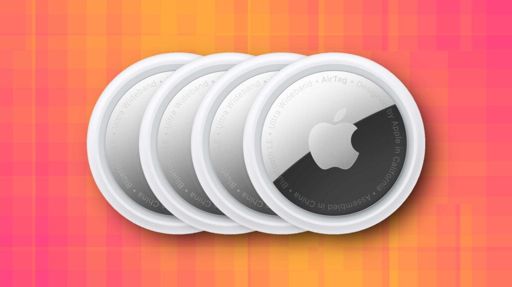 Four overlapping white circular AirTag-style trackers on a warm orange-pink checkered background.
