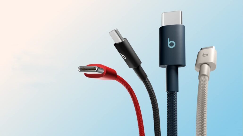 Close-up of four USB-C charging cables in red, black, dark blue, and gray fanned out against a light gradient background.