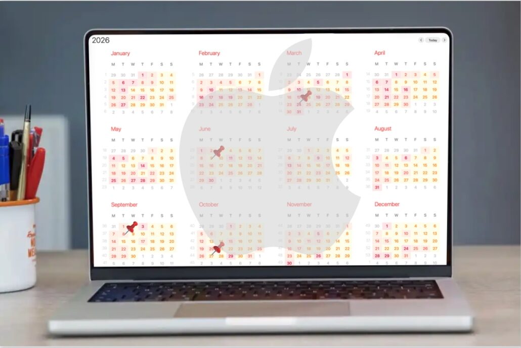 Year-long calendar grid spanning all months displayed on the laptop screen, with highlighted dates in red and orange.